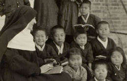 A Benedictine nun teaching young children